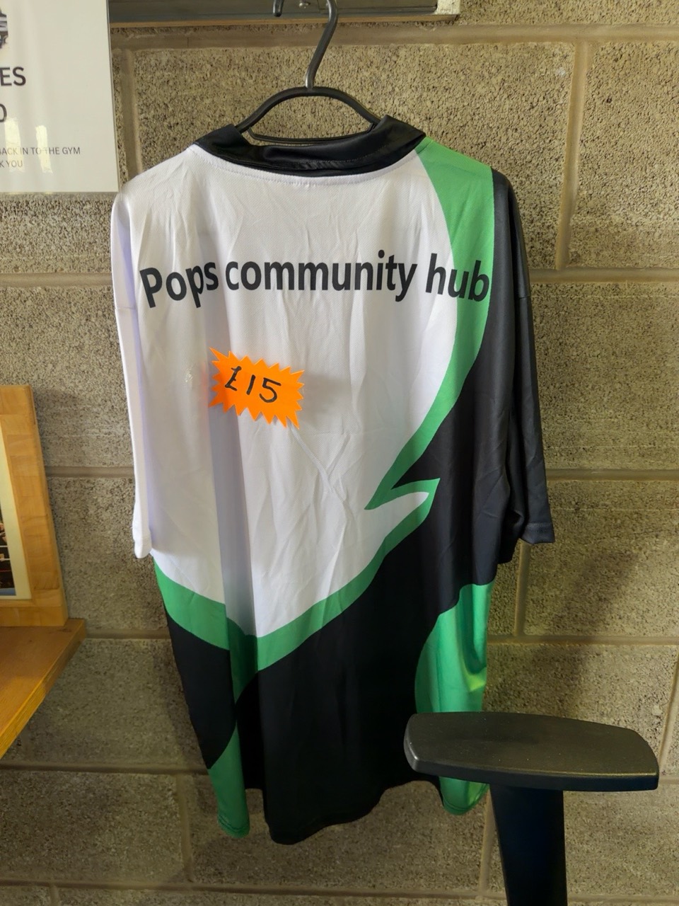 Green, black and white Pops Community Hub training shirt marked £15